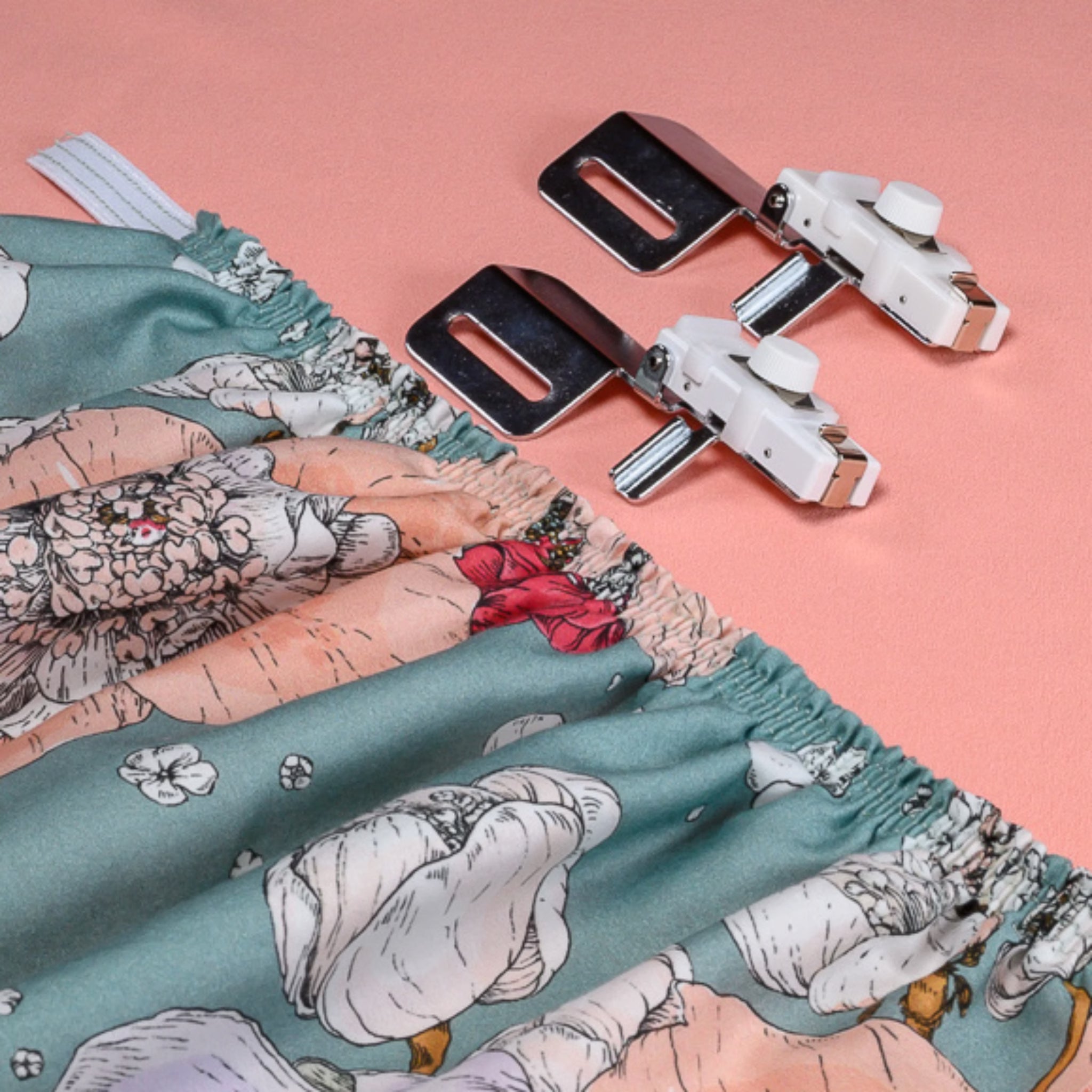 Floral-patterned fabric with elastic gathering attachment on a pink background